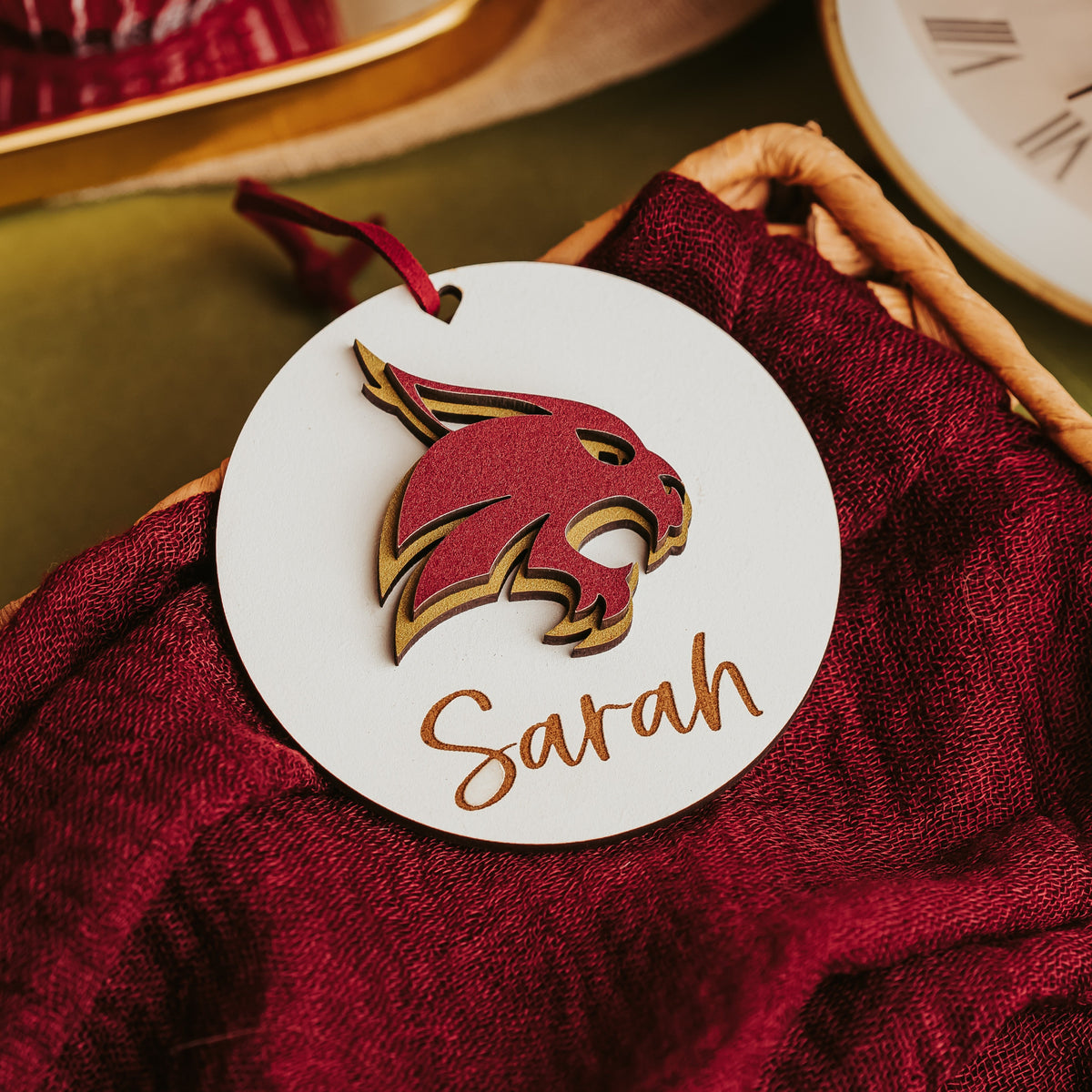 White Texas State Bobcat ornament with a layered maroon and gold Bobcat and the name Sarah in script,