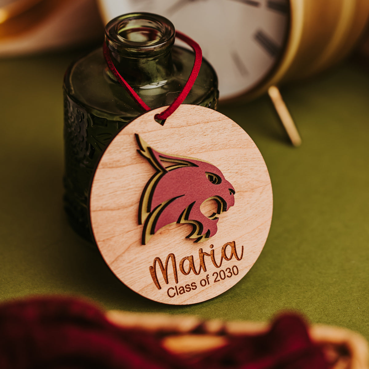 Cherry wood Texas State ornament with a raised maroon and gold Bobcat, engraved Maria, Class of 2030