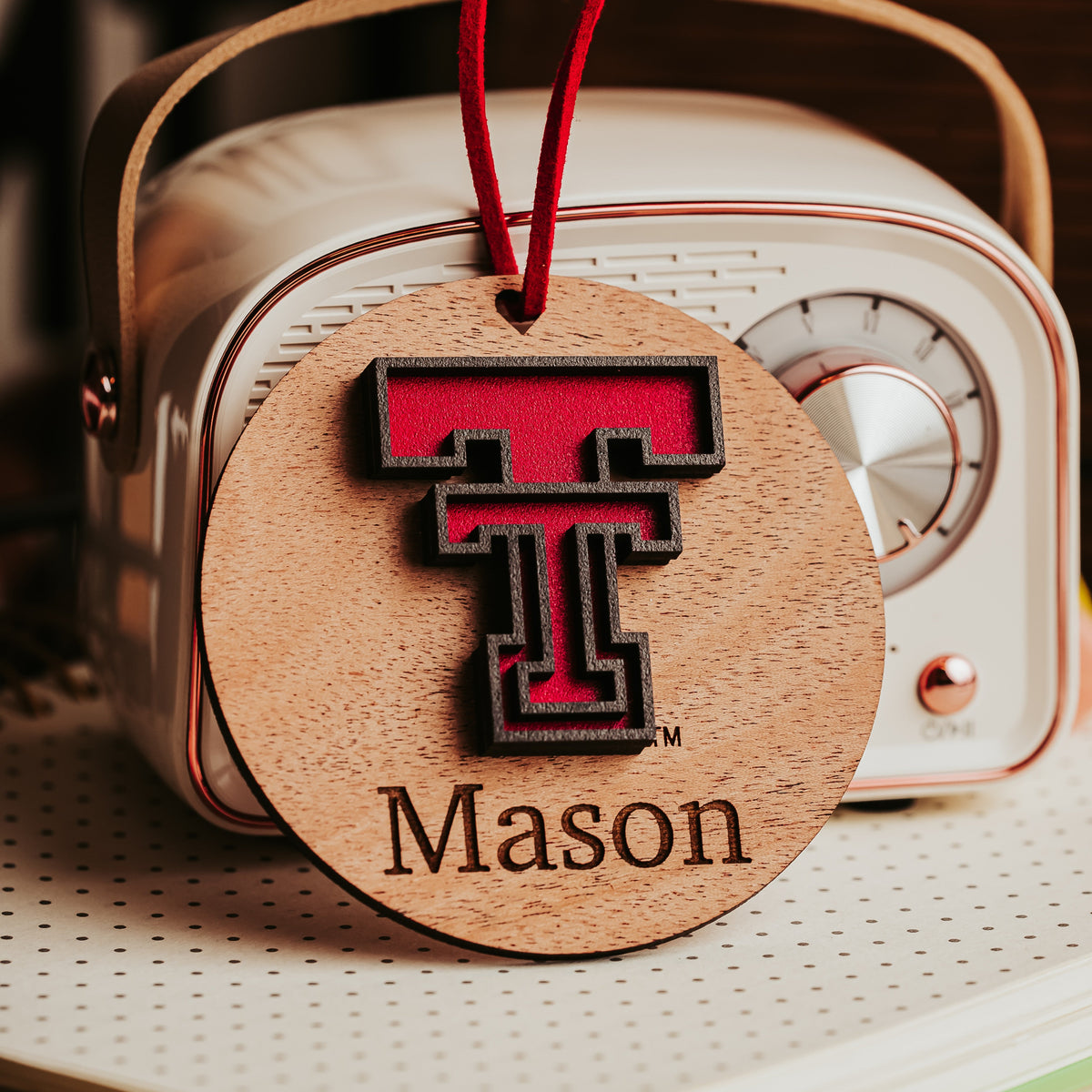 Mahogany Texas Tech ornament with a red cord, personalized with the name Mason