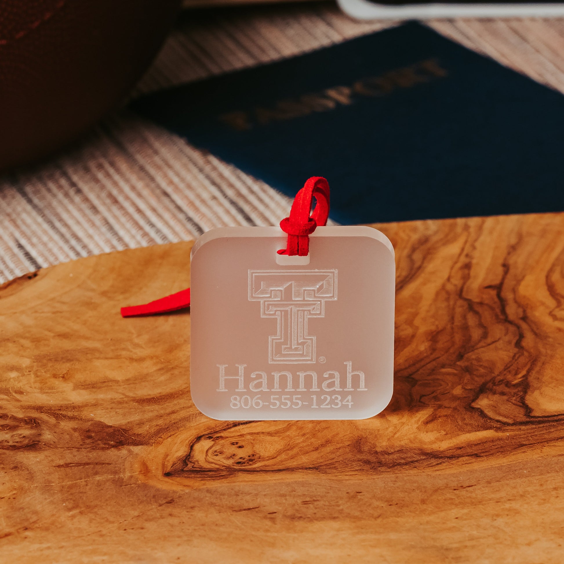 Officially Licensed Texas Tech University luggage tags featuring the TTU logo, personalized with customer's choice of 1-3 lines of information. Available in Clear, Frosted and Opaque Black acrylic by Half Turn Designs.  Shown here in frosted acrylic.