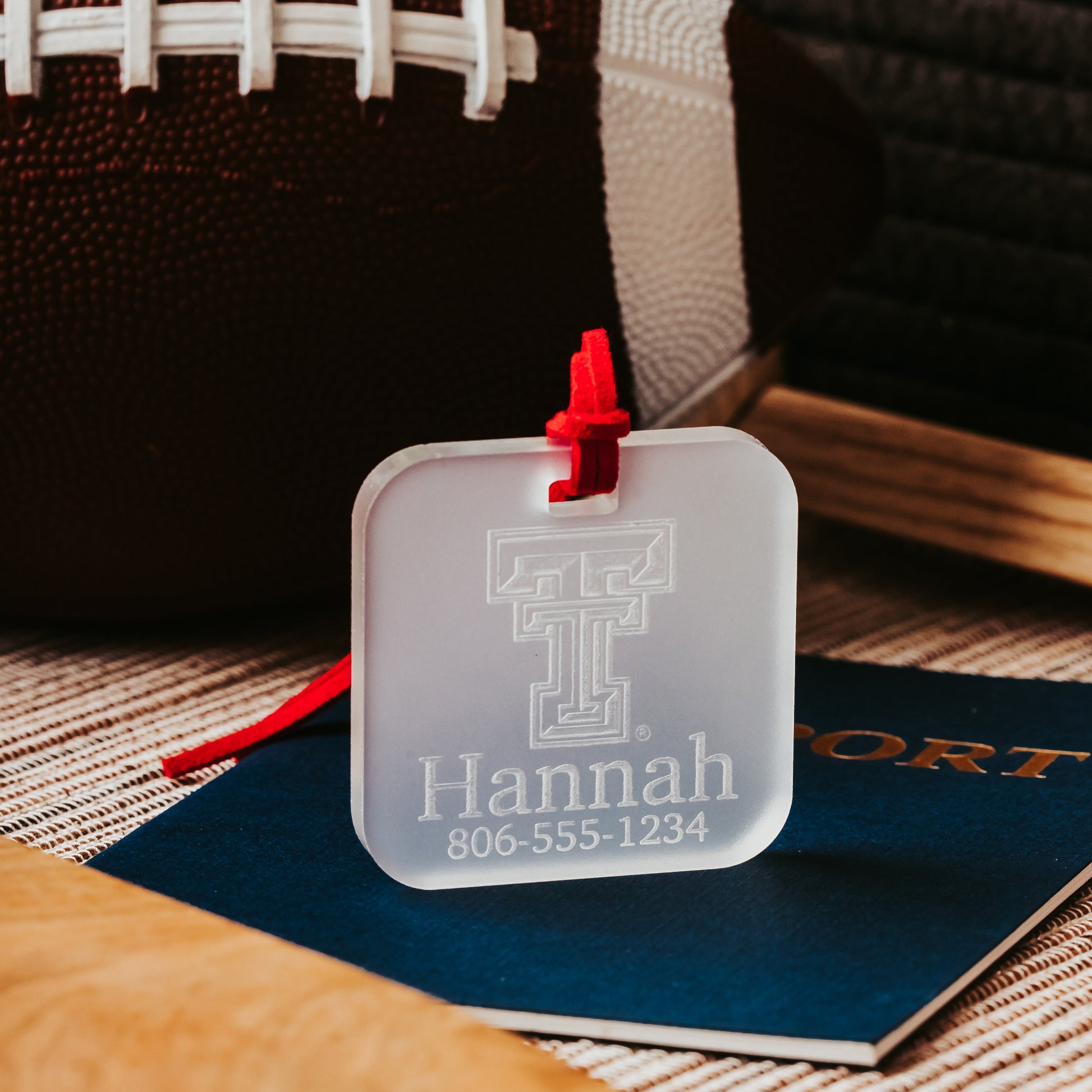 Officially Licensed Texas Tech University luggage tags featuring the TTU logo, personalized with customer's choice of 1-3 lines of information. Available in Clear, Frosted and Opaque Black acrylic by Half Turn Designs.  Shown here in frosted acrylic.