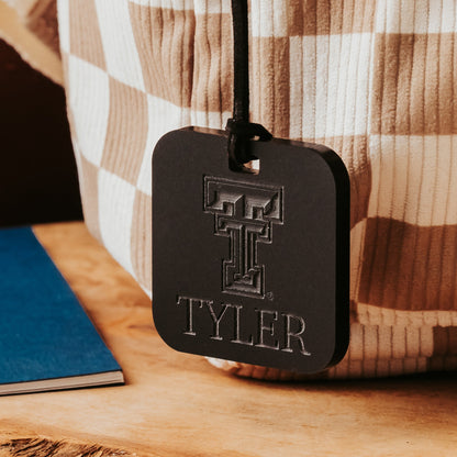Officially Licensed Texas Tech University luggage tags featuring the TTU logo, personalized with customer's choice of 1-3 lines of information. Available in Clear, Frosted and Opaque Black acrylic by Half Turn Designs.  Shown here in opaque black acrylic.