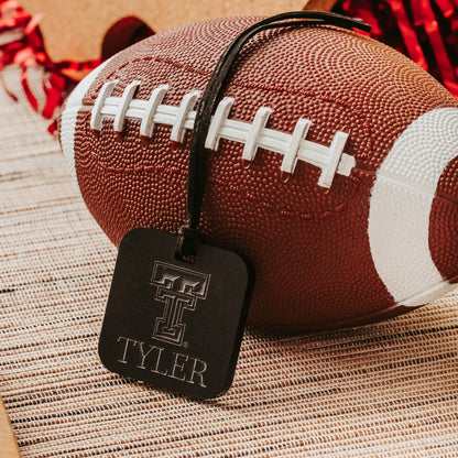 Officially Licensed Texas Tech University luggage tags featuring the TTU logo, personalized with customer's choice of 1-3 lines of information. Available in Clear, Frosted and Opaque Black acrylic by Half Turn Designs.  Shown here in opaque black acrylic.