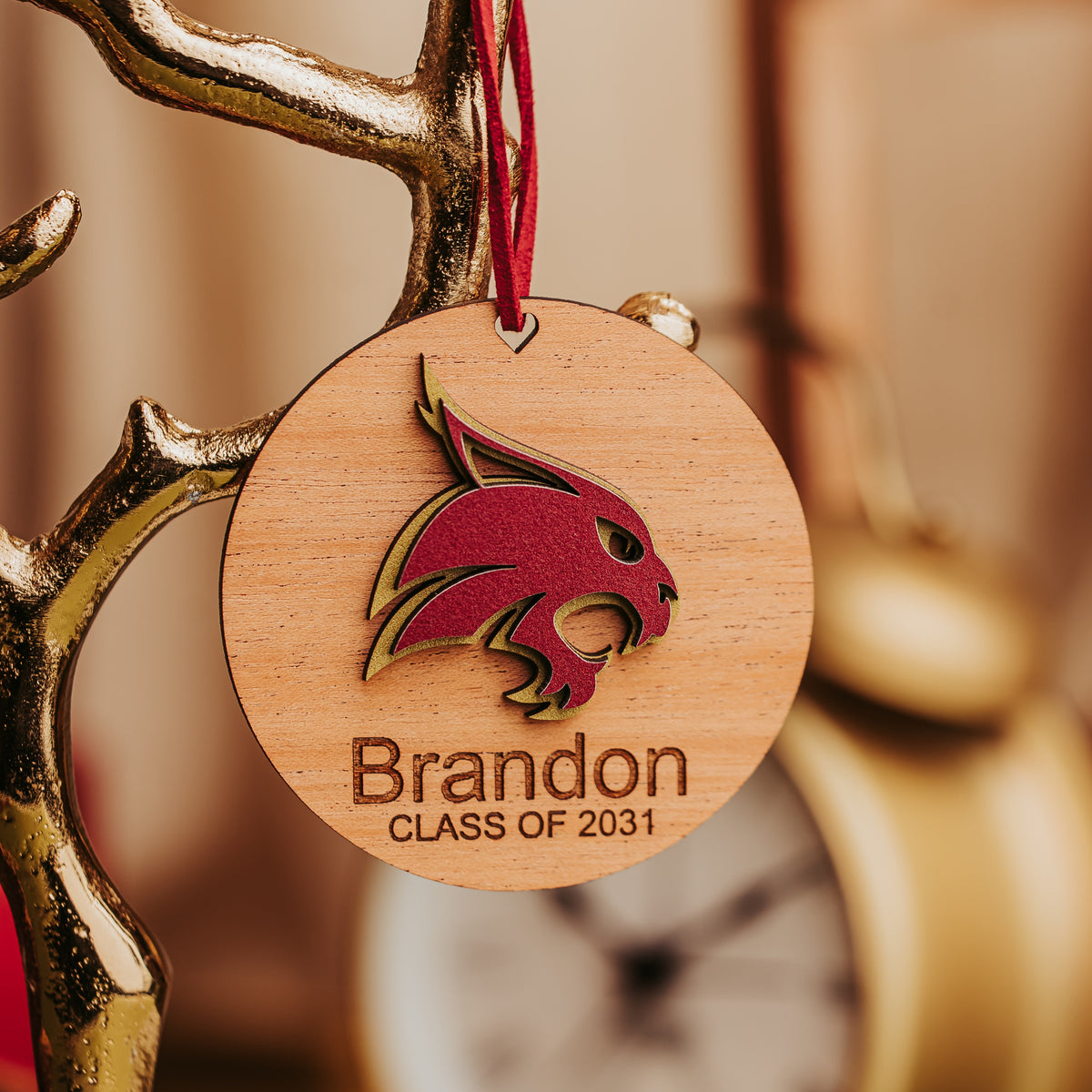 Mahogany Texas State Bobcat ornament engraved Brandon, Class of 2031, hanging by a maroon cord