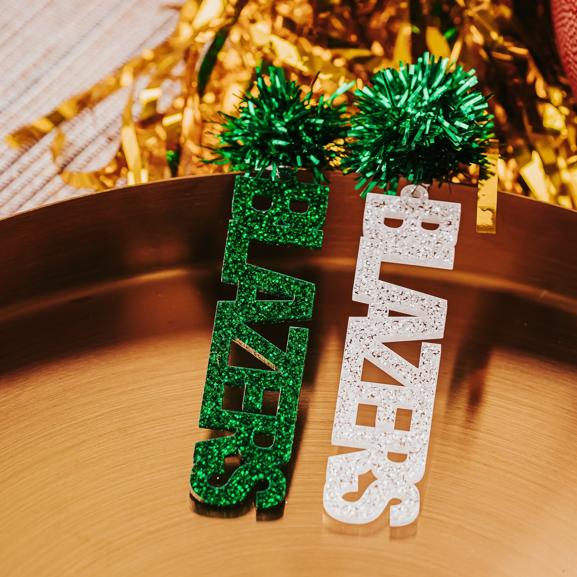 Officially Licensed University of Alabama Birmingham game day earrings in green and white glitter in your choice of 10 different earrings toppers by Half Turn Designs. Shown here with green tinsel toppers.