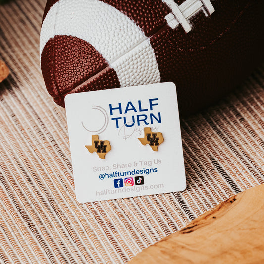 University of Houston Texas-Shaped Studs. These earrings are made from stainless steel, available in gold or silver finish and engraved with the UH Cougars logo. They are officially licensed earrings made by Half Turn Designs. Shown here in gold finish.