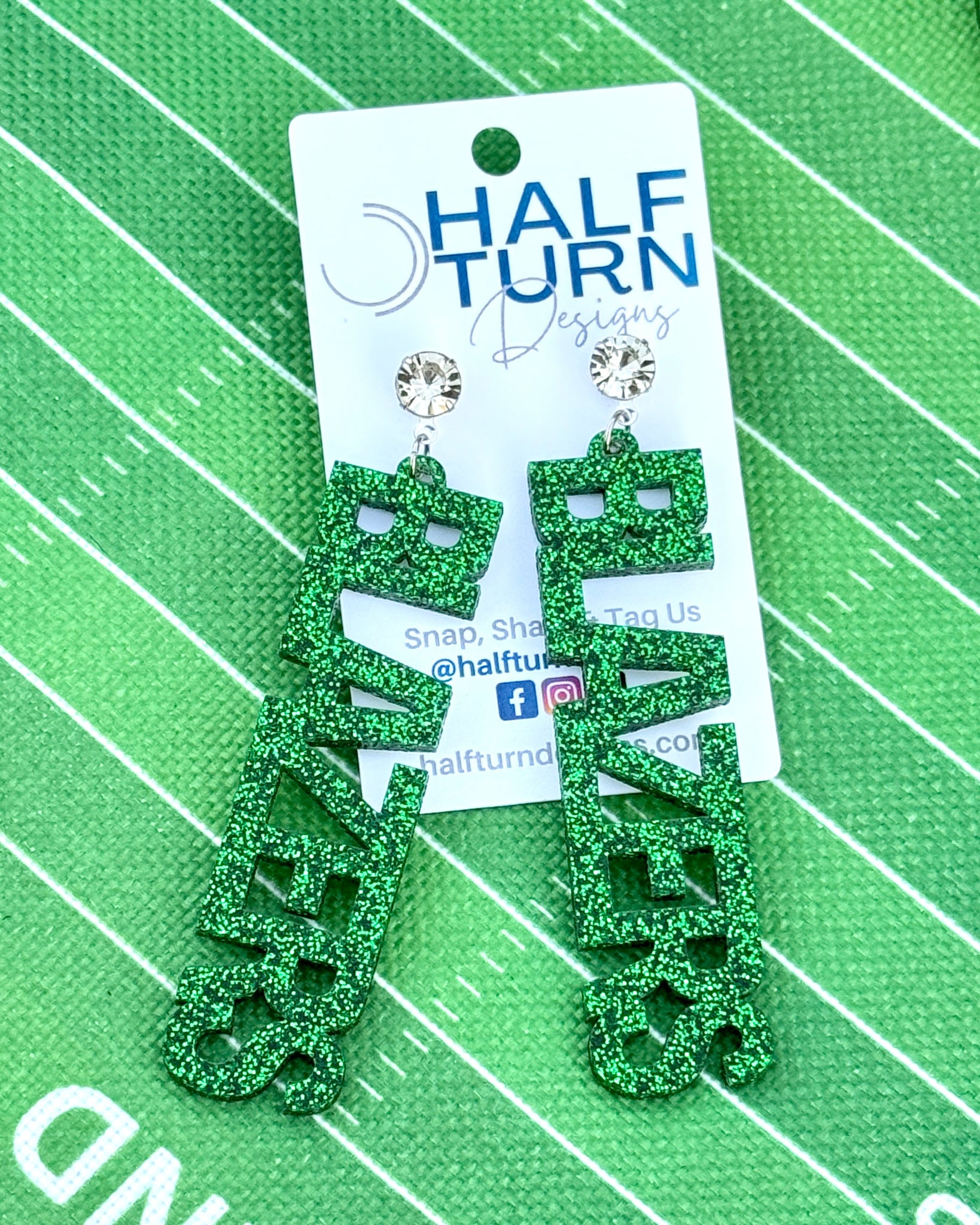 Large University of Alabama Dragons dangle acrylic earrings in green and white glitter. Shown here with rhinestone earring toppers.